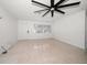 Bright living room featuring neutral walls, ceiling fan, window, and terrazzo flooring at 1672 Cambridge Dr, Clearwater, FL 33756