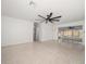 Spacious living room featuring neutral walls, a unique ceiling fan, and terrazzo flooring at 1672 Cambridge Dr, Clearwater, FL 33756