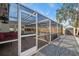 Outdoor pool and screened in deck with access to additional buildings at 1672 Cambridge Dr, Clearwater, FL 33756