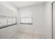 Bright, minimalist room featuring tile flooring and two large windows at 1672 Cambridge Dr, Clearwater, FL 33756