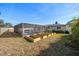 Backyard with wooden plant beds near an in-ground screened in pool and detached storage shed at 1672 Cambridge Dr, Clearwater, FL 33756