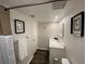 Well-lit bathroom featuring modern vanity, framed prints and a shower/tub combination at 2070 Lakeview Dr # 206, Clearwater, FL 33763