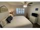 Bright bedroom featuring a ceiling fan and window dressed with white plantation shutters at 2070 Lakeview Dr # 206, Clearwater, FL 33763