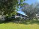 Exterior view of condominium building with lawns, mature trees, and a two-story elevation at 2070 Lakeview Dr # 206, Clearwater, FL 33763