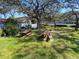 Community picnic area equipped with picnic tables and charcoal grill, set amongst lush green space at 2070 Lakeview Dr # 206, Clearwater, FL 33763