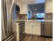 Beautiful kitchen features stainless appliances, white cabinets, quartz counters, and grey backsplash at 2070 Lakeview Dr # 206, Clearwater, FL 33763