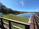 Scenic lake view with wooden dock access, ideal for fishing, boating, or enjoying the natural surroundings at 2070 Lakeview Dr # 206, Clearwater, FL 33763