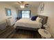 Bright bedroom featuring a lake view, ceiling fan, dresser, and modern decor at 2070 Lakeview Dr # 206, Clearwater, FL 33763