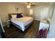 Spacious bedroom with a view of ensuite bathroom, dresser and ceiling fan at 2070 Lakeview Dr # 206, Clearwater, FL 33763