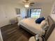 Bright bedroom featuring a lake view, ceiling fan, dresser, and modern decor at 2070 Lakeview Dr # 206, Clearwater, FL 33763