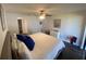 Spacious bedroom with a view of ensuite bathroom, dresser and ceiling fan at 2070 Lakeview Dr # 206, Clearwater, FL 33763