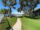 Scenic view of the lake and community dock with lush greenery and palm trees at 2070 Lakeview Dr # 206, Clearwater, FL 33763