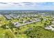 Overhead view of golf course, ponds, and multiple residences in a sprawling community at 2226 Switzerland Way # 52, Clearwater, FL 33763