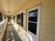 Exterior hallway with white door and glass window, showcasing natural light and an inviting entrance at 2226 Switzerland Way # 52, Clearwater, FL 33763