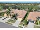 Aerial view of a neighborhood showcasing tile roofs, green lawns, and mature landscaping at 237 Shell Falls Dr, Apollo Beach, FL 33572