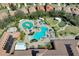 Aerial view of the community pool featuring a lazy river, sun deck, and lush landscaping at 237 Shell Falls Dr, Apollo Beach, FL 33572