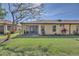 Well-manicured backyard with lush green grass, mature trees, and a screened lanai at 237 Shell Falls Dr, Apollo Beach, FL 33572