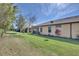 Backyard with green lawn, mature trees, and a view of neighboring homes at 237 Shell Falls Dr, Apollo Beach, FL 33572