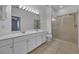 Bathroom featuring double sinks, white cabinets, and a glass-enclosed shower at 237 Shell Falls Dr, Apollo Beach, FL 33572