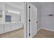 Bright bathroom with dual sinks, white cabinets and a view to the walk-in closet at 237 Shell Falls Dr, Apollo Beach, FL 33572