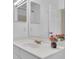 Bathroom vanity with a white countertop, a flower accent and brushed gold faucet at 237 Shell Falls Dr, Apollo Beach, FL 33572