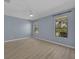 Bedroom with wood-look flooring, ceiling fan, and bright natural light from windows at 237 Shell Falls Dr, Apollo Beach, FL 33572