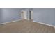 Spacious bedroom with wood-look flooring and a doorway to another room at 237 Shell Falls Dr, Apollo Beach, FL 33572