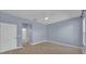 Bright bedroom with wood-look flooring, ceiling fan, and a doorway to the bathroom at 237 Shell Falls Dr, Apollo Beach, FL 33572