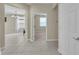 Hallway featuring tile flooring, chandelier, and doorway to bedroom at 237 Shell Falls Dr, Apollo Beach, FL 33572