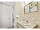 Bathroom with large mirror, sink, and door to adjacent room at 2441 Persian Dr # 53, Clearwater, FL 33763