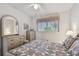 Cozy bedroom featuring a patterned quilt, soft lighting, and ample storage space at 2441 Persian Dr # 53, Clearwater, FL 33763