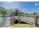 Community dock along a scenic pond with surrounding landscaping and nearby buildings at 2441 Persian Dr # 53, Clearwater, FL 33763