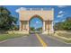 Grand entrance archway with statues and globe in the distance at 2441 Persian Dr # 53, Clearwater, FL 33763