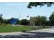 Community grounds with art including a large globe, American flag, and attractive buildings and landscaping at 2441 Persian Dr # 53, Clearwater, FL 33763