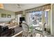 Cozy sunroom living area with a glass table and white wicker chairs at 2441 Persian Dr # 53, Clearwater, FL 33763