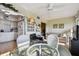 Inviting living space with wicker chairs, a glass table, and seamless transition to the kitchen at 2441 Persian Dr # 53, Clearwater, FL 33763