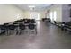 A large meeting space with a projector screen and multiple tables and chairs provides space to gather at 2441 Persian Dr # 53, Clearwater, FL 33763