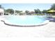 Inviting outdoor swimming pool with lounge chairs and umbrellas, ideal for relaxation and recreation at 2441 Persian Dr # 53, Clearwater, FL 33763