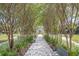 Tree-lined walkway with benches leading to a globe feature at 2441 Persian Dr # 53, Clearwater, FL 33763