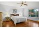 Bedroom with wood floors, window, and ceiling fan at 2517 Lynx Rd # 20, Sun City Center, FL 33573