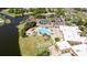 Aerial view of community pool, lounge chairs, and gazebo near lake at 2517 Lynx Rd # 20, Sun City Center, FL 33573