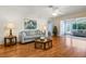 Open living room with hardwood floors, leading to a sunroom at 2517 Lynx Rd # 20, Sun City Center, FL 33573