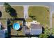 An aerial view showcasing a home with a backyard pool, lush greenery, and a well-manicured lawn at 2749 16Th N Ave, St Petersburg, FL 33713