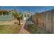 Backyard featuring a green painted house with a white door and a walkway leading to a mailbox and fence at 2749 16Th N Ave, St Petersburg, FL 33713