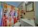 Cozy bathroom featuring a vanity with a sink and a shower with a colorful, vibrant African-themed curtain at 2749 16Th N Ave, St Petersburg, FL 33713