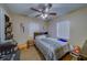 A cozy bedroom features a ceiling fan, natural light, and comfortable bedding in a neutral color palette at 2749 16Th N Ave, St Petersburg, FL 33713