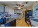 A cozy kitchen featuring stainless steel appliances, wood-look floors, a ceiling fan, and a breakfast bar at 2749 16Th N Ave, St Petersburg, FL 33713