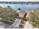 Aerial view of the property showcases a waterfront location with a well-maintained home and landscaping at 2811 Butterfly Landing Dr, Land O Lakes, FL 34638