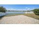 Paver patio overlooking the lake with fenced yard, beautiful view and sunny skies at 2811 Butterfly Landing Dr, Land O Lakes, FL 34638