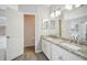 Bathroom featuring double vanity, granite countertop, and a separate toilet room at 2811 Butterfly Landing Dr, Land O Lakes, FL 34638